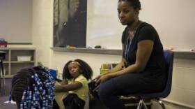 Ayana Coles, right, sits with students at Eagle Creek Elementary School. At Eagle Creek, students of color make up 77 percent of the student body, and all but four of the schoolâ€™s 37 staff are white. Coles has led conversations about race with colleagues throughout the year.