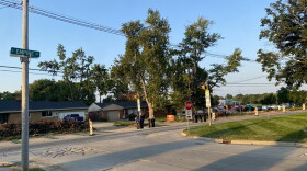 Landscape of Empire Street with construction cones along the roadside. Bloomington High School can be seen in the distance.