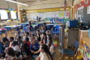 Students sit in front of an oscillating fan on the first day of school on Sept.