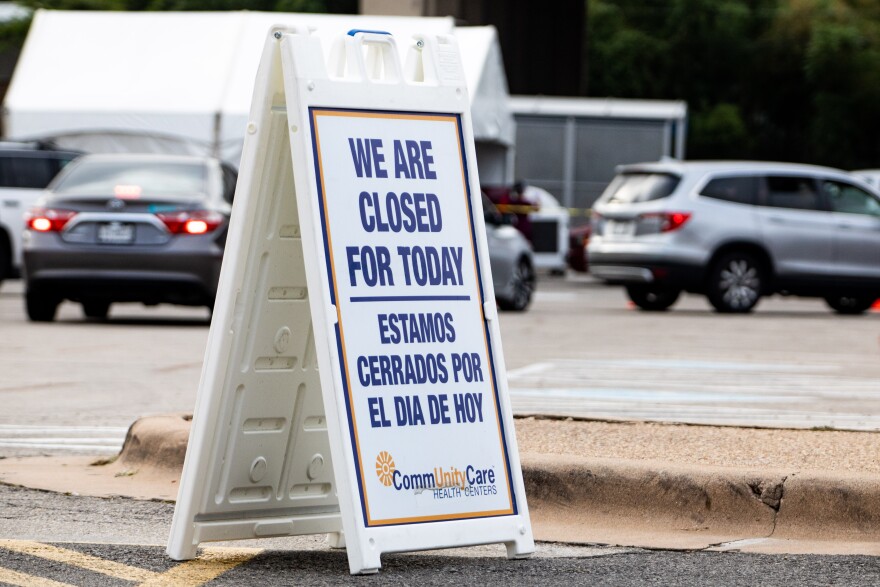 A sign indicates CommUnityCare's drive-thru testing is closed for the day. Locations have to close early if they reach capacity.