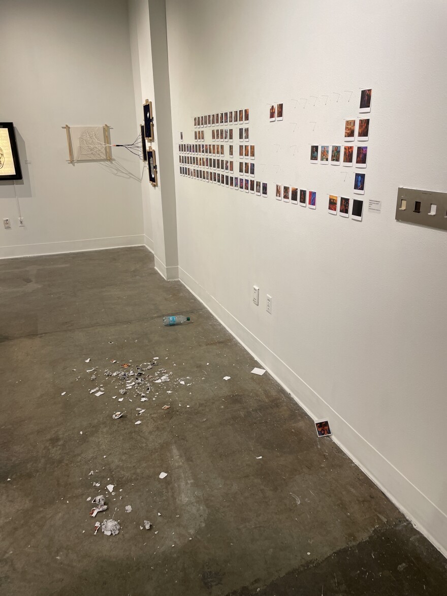 Pieces of chewed up artwork lie on the floor in the University of Alaska Fairbanks art exhibit on Jan. 13.