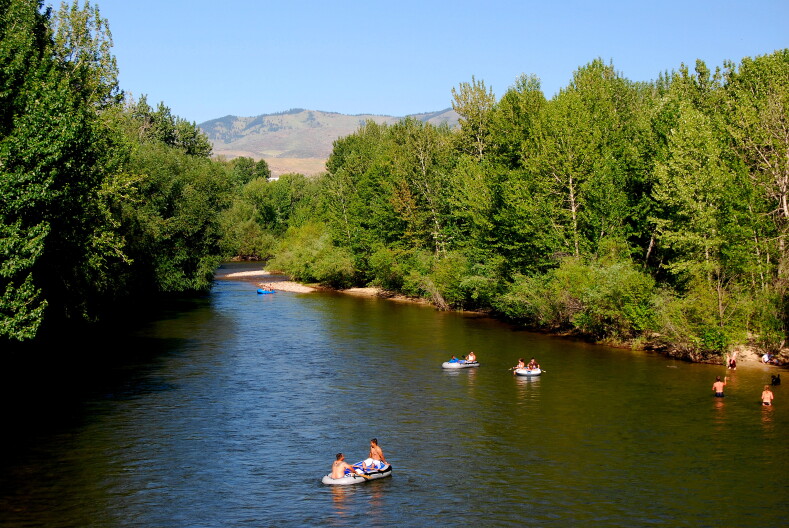 People float down the Boise River on a warm day.