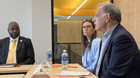 Sen. John Boozman (right) and Gov. Sarah Huckabee Sanders (middle) speak with catfish farmers and aquaculture experts at the University of Arkansas at Pine Bluff, as the school's Chancellor Anthony Graham (left) listens.