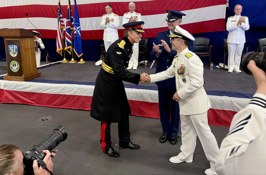 British Gen. Nick Perry shakes hands with U.S. Vice Admiral Doug Perry during the change of command on USS Nimitz.