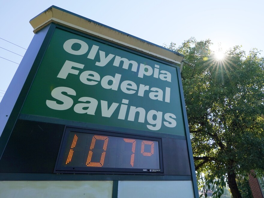 A display at an Olympia Federal Savings branch shows a temperature of 107 degrees Fahrenheit, Monday, June 28, 2021, in the early evening in Olympia, Wash.