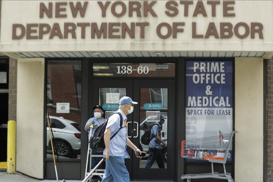 Pedestrians pass the New York State Department of Labor office.