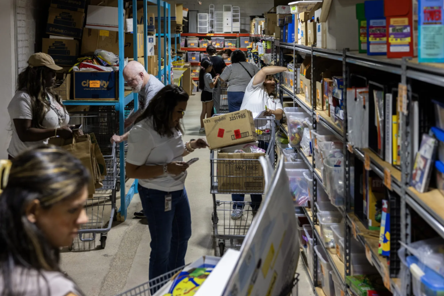 Educators scan shelves of materials during the reopening of The Welman Project at their new headquarters on May 19, 2026. Teachers have access to a variety of materials, books, games and furniture.