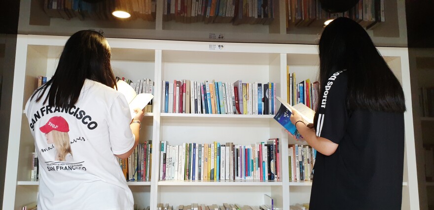 Two young women browse the library at the National Center for Youth Internet Addiction Treatment in Muju, South Korea.