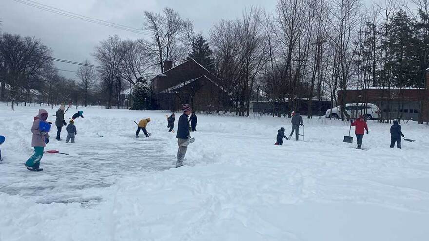 Families in Shaker Heights gather for a snow shoveling party to clear the ice rink in the Onaway neighborhood after a major snowfall over the Martin Luther King Jr. Day holiday. [Matt Erman / Ideastream Public Media]