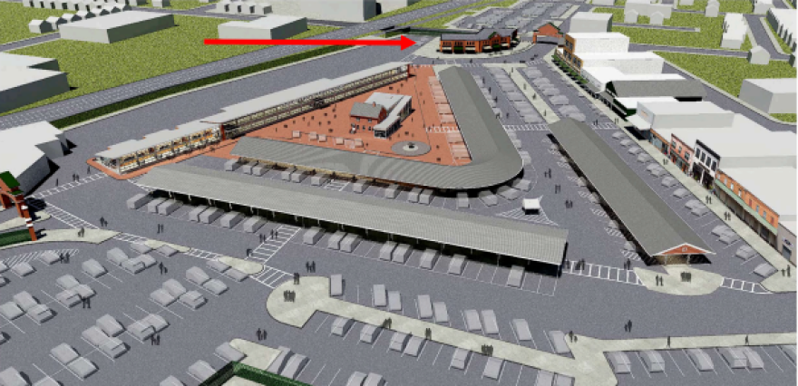 A red arrow points to where a new storefront building – possibly with upper floors of apartments – could be built at the North Union Street entrance to the Rochester Public Market. The areal rendering looks west over the market with North Union Street in the background.