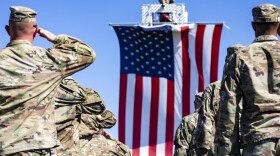 Soldiers with the 76th Infantry Brigade Combat Team salute the U.S. flag during their departure ceremony at Camp Atterbury on Friday, Sept. 30, 2022. An Indianapolis guardsman died last week while deployed to Iraq