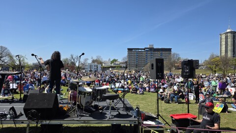 Stacey Woolley (on stage), a member of the Tulsa Public Schools board, addresses a crowd at Dream Keepers Park as part of Tulsa's third "No Kings" protest on March 28, 2026.