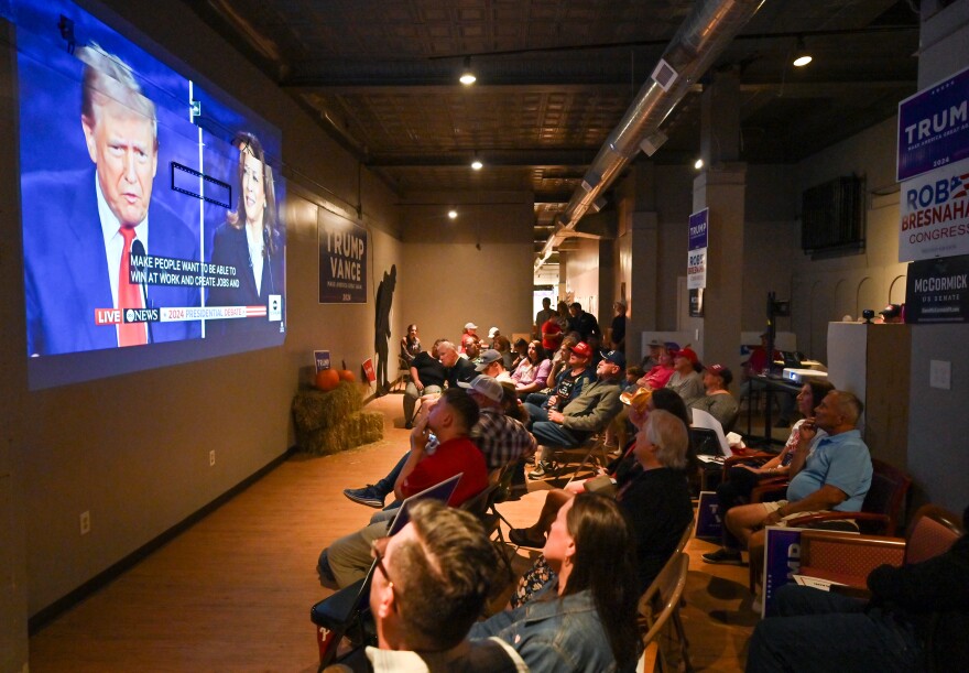 Former President Donald Trump and Vice President Kamala Harris are projected on a wall at the Republican Headquarters in Kingston, Luzerne County, as area Republicans gathered to watch the presidential debate Tuesday night.