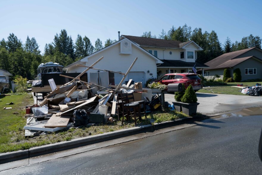 Juneau residents pile up belongings damaged by a glacial outburst flood.