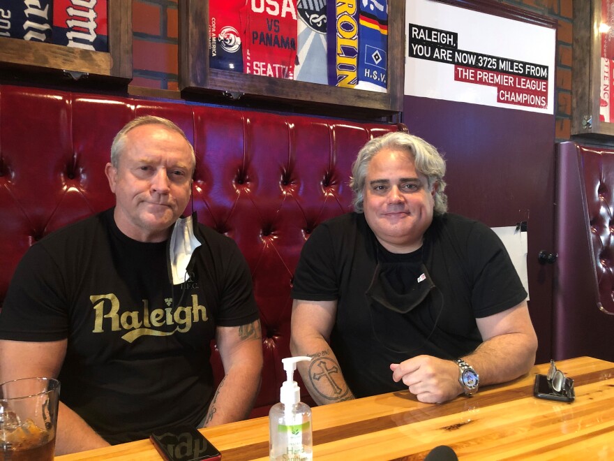 Darren Bridger, left, and Mike Ruiz, co-owners of The London Bridge Pub, on Hargett Street, in Raleigh. Rioters smashed the storefront windows of the pub and destroyed property inside after racial justice protests turned violent last May, in Raleigh.