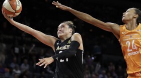 Las Vegas Aces guard Kayla McBride shoots around Phoenix Mercury forward DeWanna Bonner during the second half of a WNBA basketball game Wednesday, Aug. 1, 2018, in Las Vegas. The Aces refused to play a game in August 2018 citing injury risks, something no women's team had ever done. (John Locher/AP)