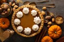 Sweet pumpkin pie decorated with whipped cream overhead shot with copy space