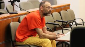 Aaron “Scott” Merritt holds a copy of the indictment from his criminal case while being arraigned on Nov. 4 in Kenai.