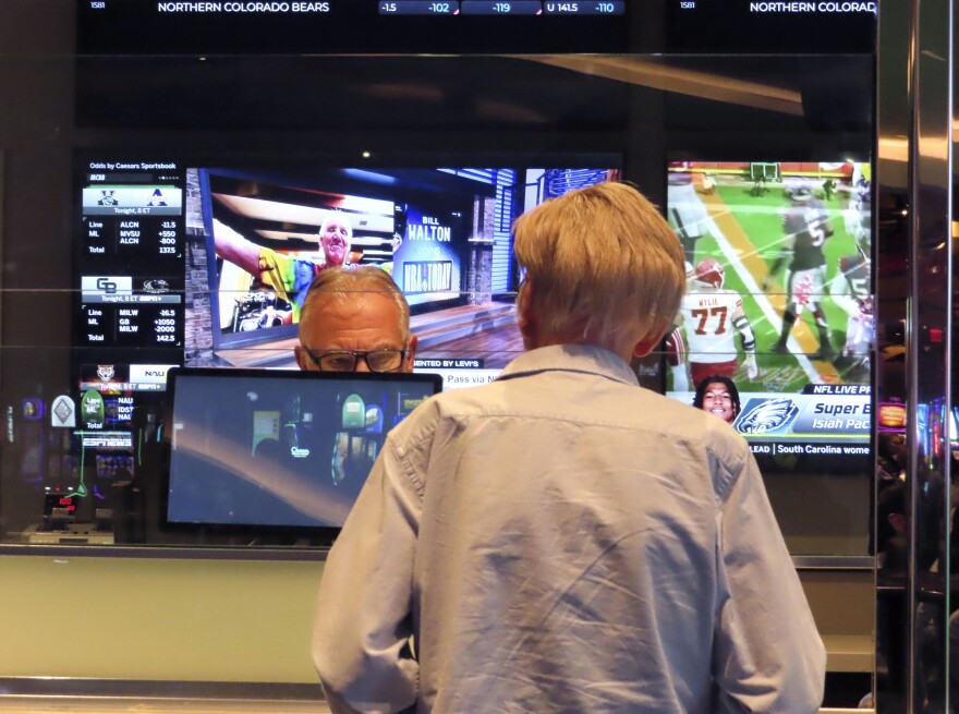 A customer, right, makes a sports bet at the Ocean Casino Resort in Atlantic City, N.J., Monday, Feb. 6, 2023.