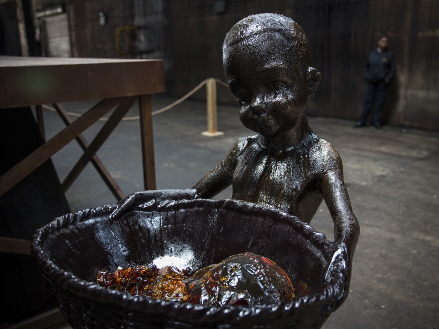 The candy sculptures have been disintegrating so fast that Walker began throwing pieces of the broken boys into the baskets of the ones that are still standing.