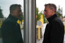 Commissioner of U.S. Customs and Border Protection Rodney Scott is reflected in a window as he speaks with an officer in a border crossing booth during a visit at the Point Roberts port of entry between the United States and Canada, Thursday, Oct. 22, 2026, in Point Roberts, Wash.