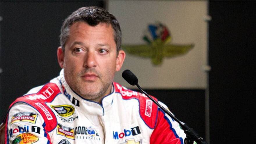 FILE: Tony Stewart listens to a question during a press conference before Brickyard 400 practice at the Indianapolis Motor Speedway in 2016. Stewart, who retired from driving after the 2016 NASCAR season, settled a wrongful death lawsuit with the family of Kevin Ward Jr. April 12, 2018.