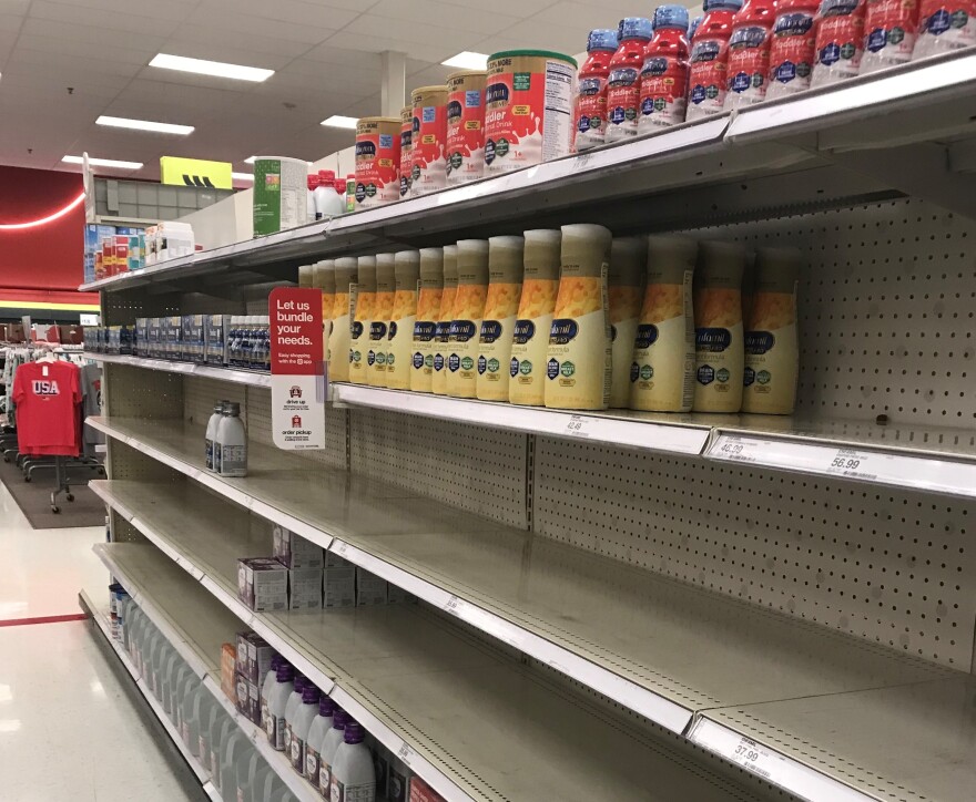 Nearly-bare shelves are seen in the formula aisle at a Target store in Monroe.