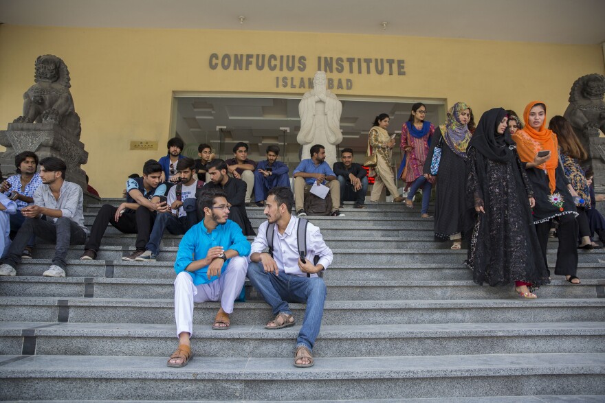 Abbas sits with another student, Wajahat Usmani, outside Islamabad's Chinese-run Confucius Institute, which is trying to teach Pakistani students about Chinese culture.