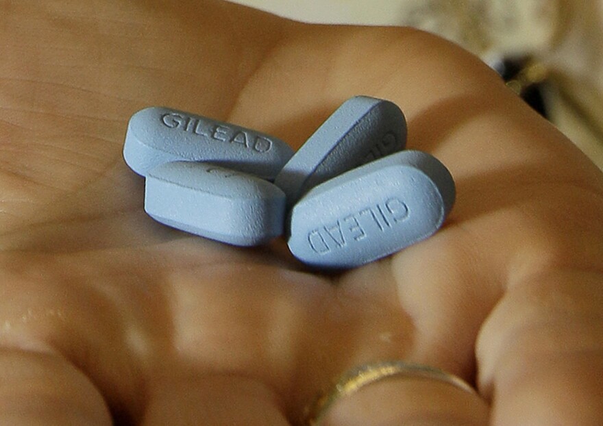 FILE - In this May 10, 2012, file photo, a doctor holds Truvada pills at her office in San Francisco. New research shows more promise for using AIDS treatment drugs, such as Truvada, as a prevention tool, to help keep uninfected people from catching HIV during sex with a partner who has the virus. Truvada has been shown to help prevent infection when one partner has the virus and one does not, but the evidence so far has been strongest for male-female couples.