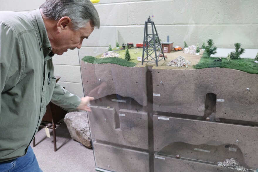 Frank “Bo” Moodie IV uses a diorama on display at the Ben E. Clement Mineral Museum in Marion, Ky. to describe the fluorspar mining process.