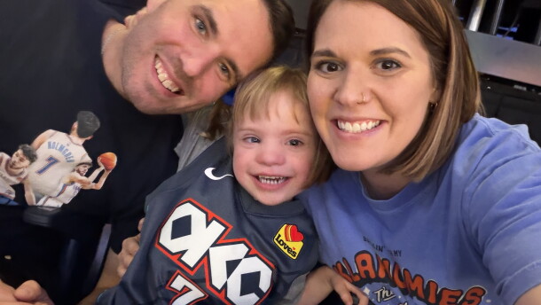 Ross and Elizabeth Duren pose with their five-year-old daughter, Gentry, at an Oklahoma City Thunder game. They attended the game through a grant from the Sam the I Can Man Foundation.