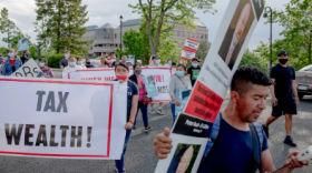 Protestors with the Recovery for All coalition march in 2021 with signs that ask for taxing the wealthy to help low- and middle-income families recover from the pandemic. The coalition is among the groups watching to see how Gov. Ned Lamont's budget will address inequalities.
