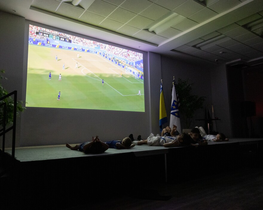 A group of children watch the game in support of Bosnia.