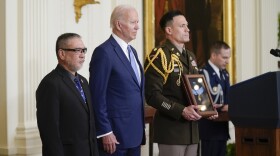 President Joe Biden presents the Medal of Honor to Staff Sgt. Edward Kaneshiro for his actions on Dec. 1, 1966, during the Vietnam War, as his son John Kaneshiro accepts the posthumous recognition during a ceremony in the East Room of the White House, Tuesday, July 5, 2022, in Washington. (AP Photo/Evan Vucci)