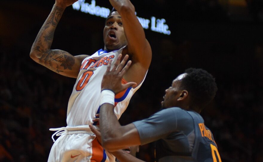 Florida's Kasey Hill (0) draws a foul on Tennessee's Kevin Punter (0) while driving the lane in the first half. (Greenberry Taylor/WUFT News)