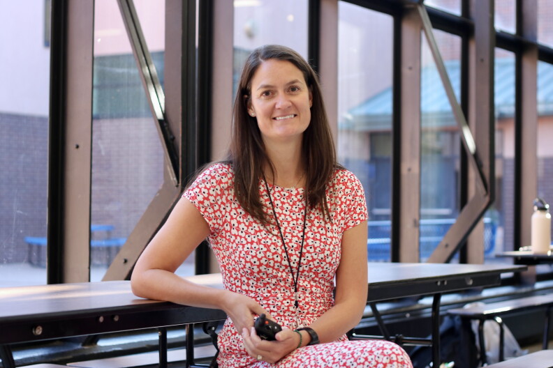 A portrait of Principal Hillary Hienton in the school cafeteria.