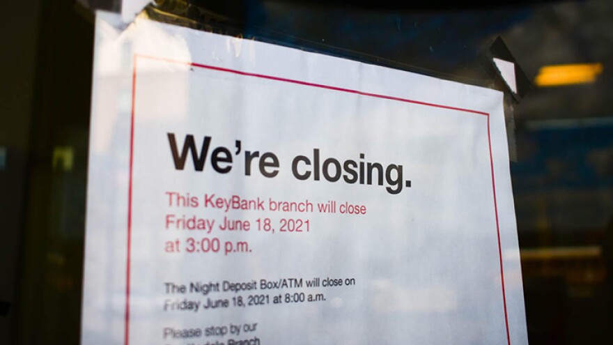 A sign on the front of a former KeyBank branch in South Bend warns customers it will be closing.