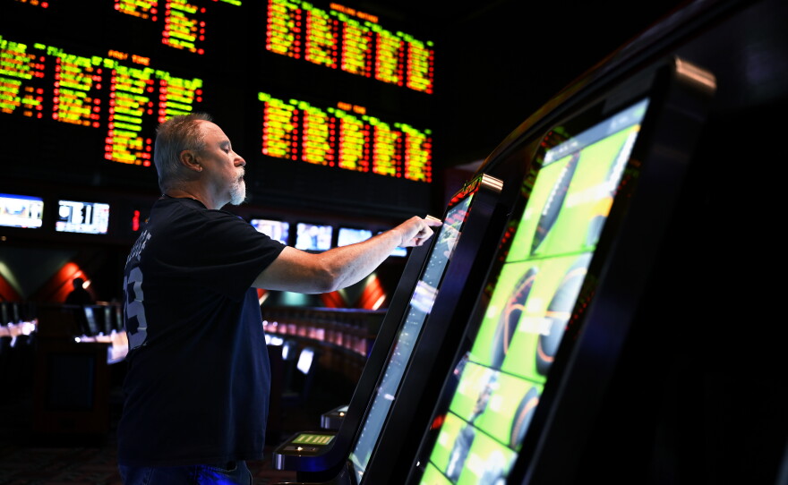 John Seaton, 59, of New York makes his picks during a soft launch of sports betting at Foxwoods Resort Casino on Sept. 30, 2021, in Ledyard, Connecticut.