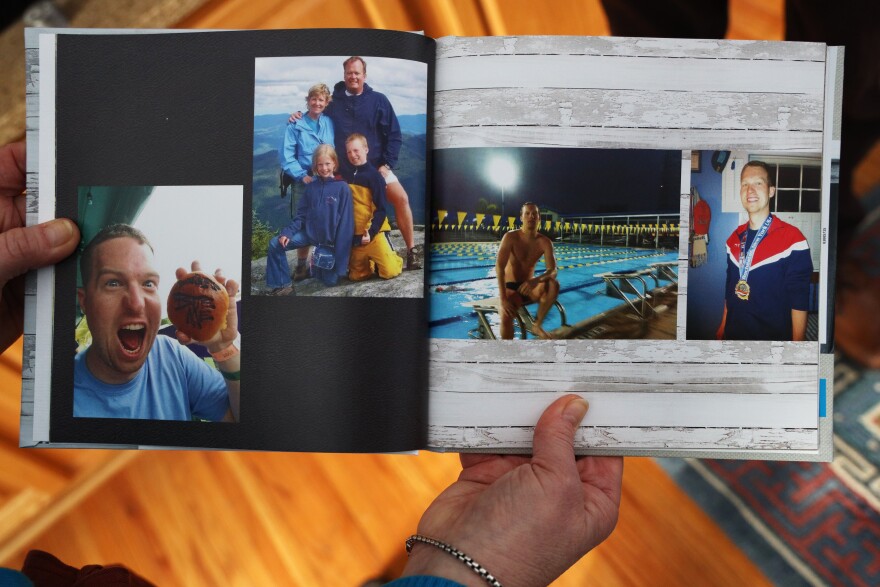 Mary Karol Matchett, holds a book wiht a collection of photos of her son Scott that was made after his death. Scott, who is deaf, had trouble communicating with police while experiencing metal heath crisis because an interpreter was never provided by the police department.(photo by Max Schulte)