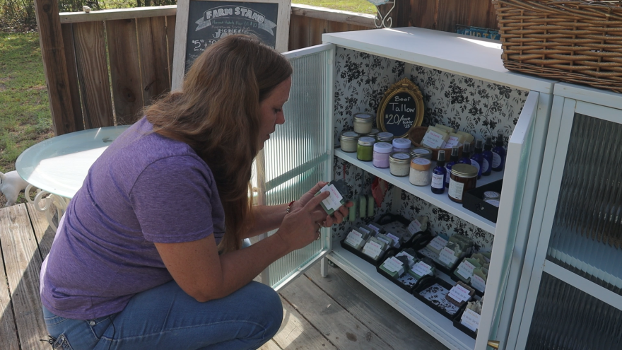 Farm Stand Girl owner Brianna Havatian lists the ingredients of her homemade soap. (Emily Drelick/WUFT News)