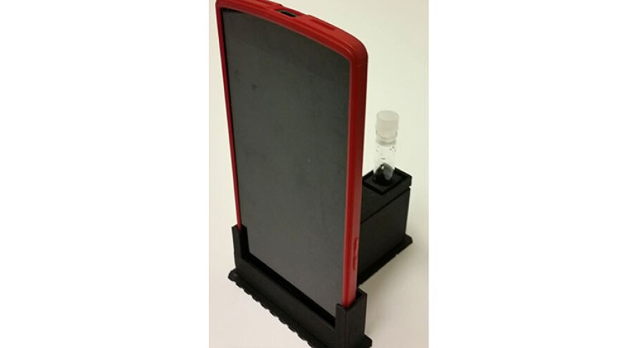 The cradle uses the phone's camera to detect low light from E. coli.