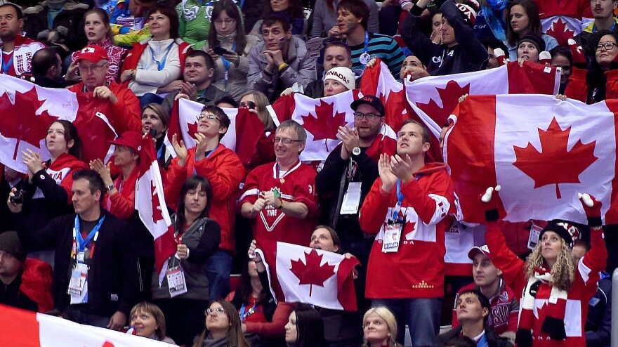 Canada fans cheer during a men's hockey game between Austria and Canada at the Winter Olympics in Sochi, Russia, on Friday.