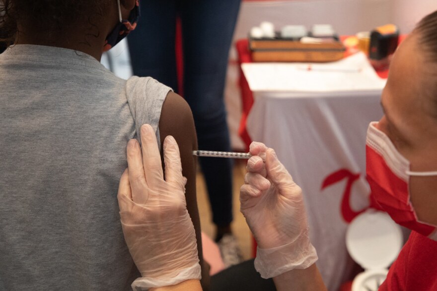 A child gets vaccinated against COVID-19 at a clinic in November. 