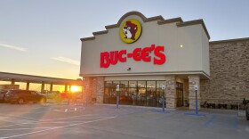 the exterior of  a Buc-ee's store with the sun rising behind it