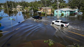 Vehicles drive through flood waters in the aftermath of Hurricane Milton in Lake Maggiore in St. Petersburg in 2025.