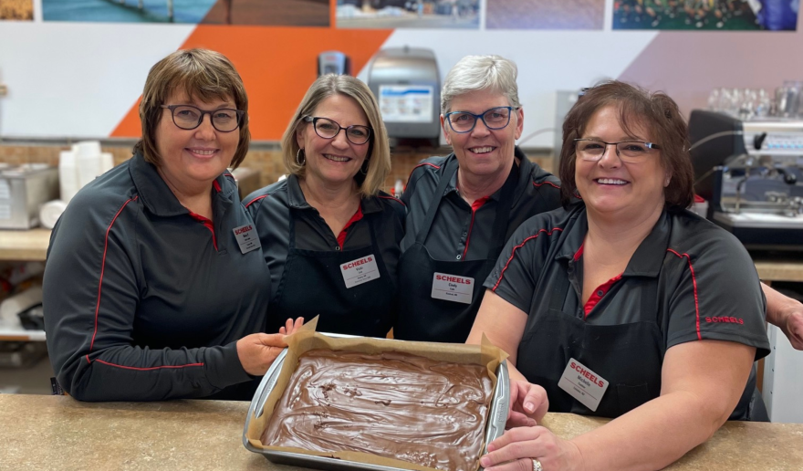 Cafe Robert Staff hold up a pan of scotcherooos in Fargo Scheel's Home & Hardware Cafe