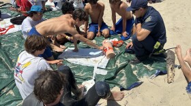 Kids in a junior lifeguard program learn some basic trauma care techniques as a part of the the international Stop The Bleed program. The program teaches people how to apply a tourniquet, and plug open, bleeding wounds.