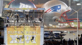 Zip-line riders finish their ride down the line over part of the Super Bowl Village on Thursday in Indianapolis. The New England Patriots are scheduled to face the New York Giants in NFL football's Super Bowl XLVI Feb. 5.