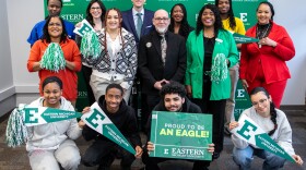 Officials from Eastern Michigan University, Ann Arbor Public Schools, and Ypsilanti Community Schools stand with EMU students in celebration of the university's new direct admissions program.