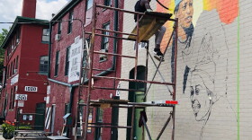 Patrick Gono working on the Front Street Mural.